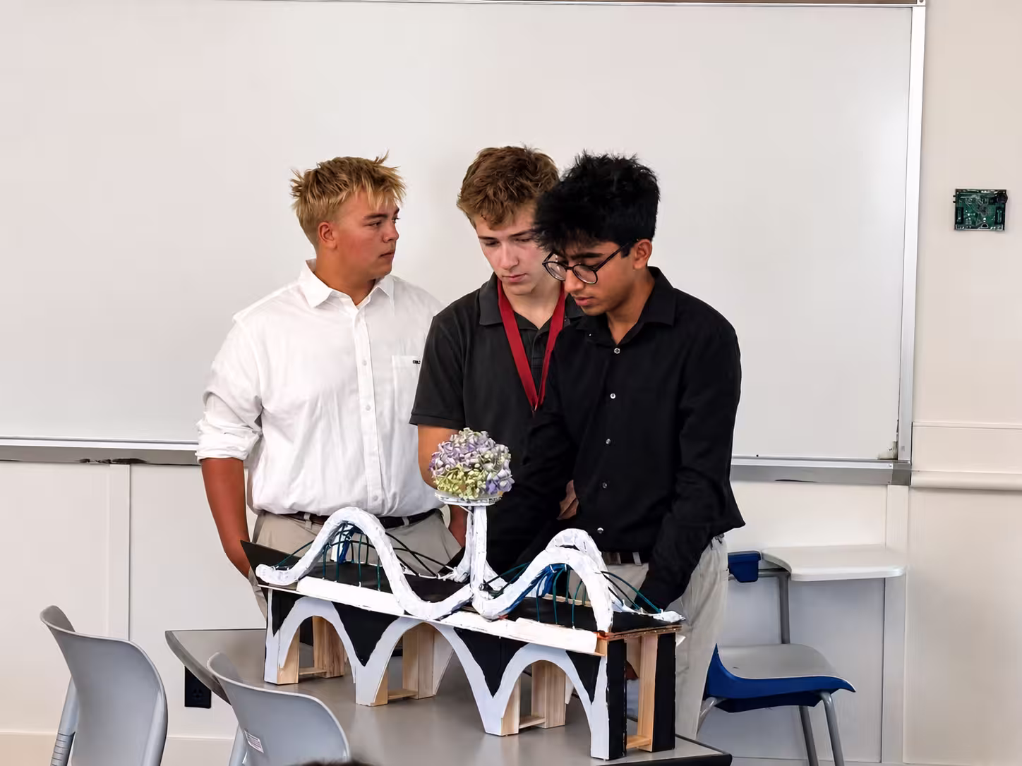 Pathway students reviewing a completed bridge model together